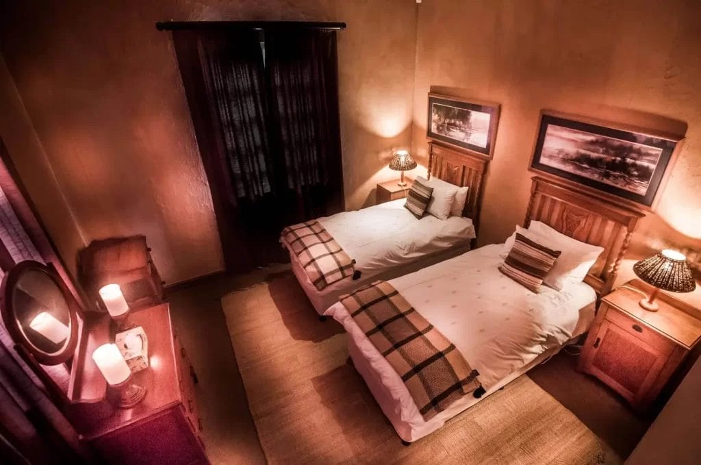 A cozy twin bedroom with soft lighting and matching bedside tables.