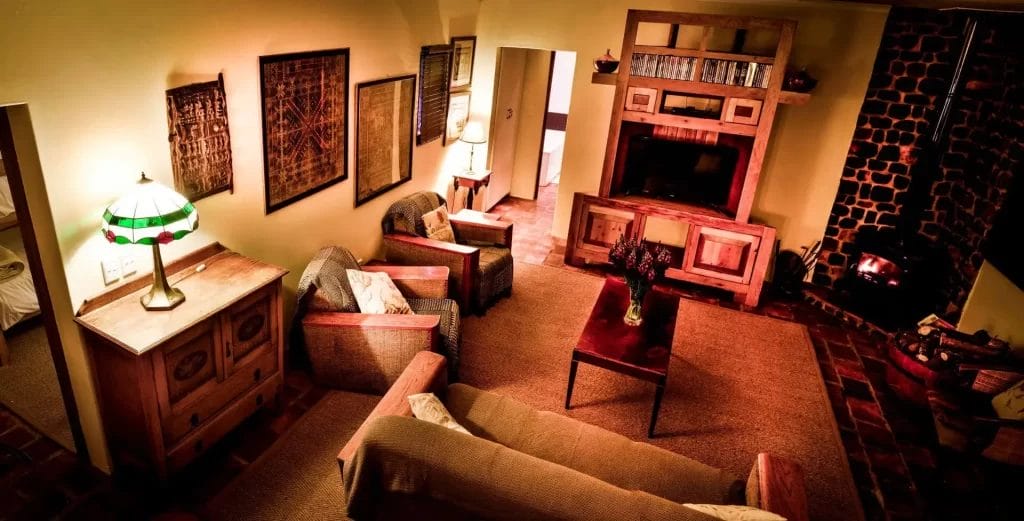 Cozy living room with warm lighting, a fireplace, and traditional decor.